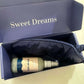 A luxurious blue package containing the Better Sleep Mist and a matching sleep mask