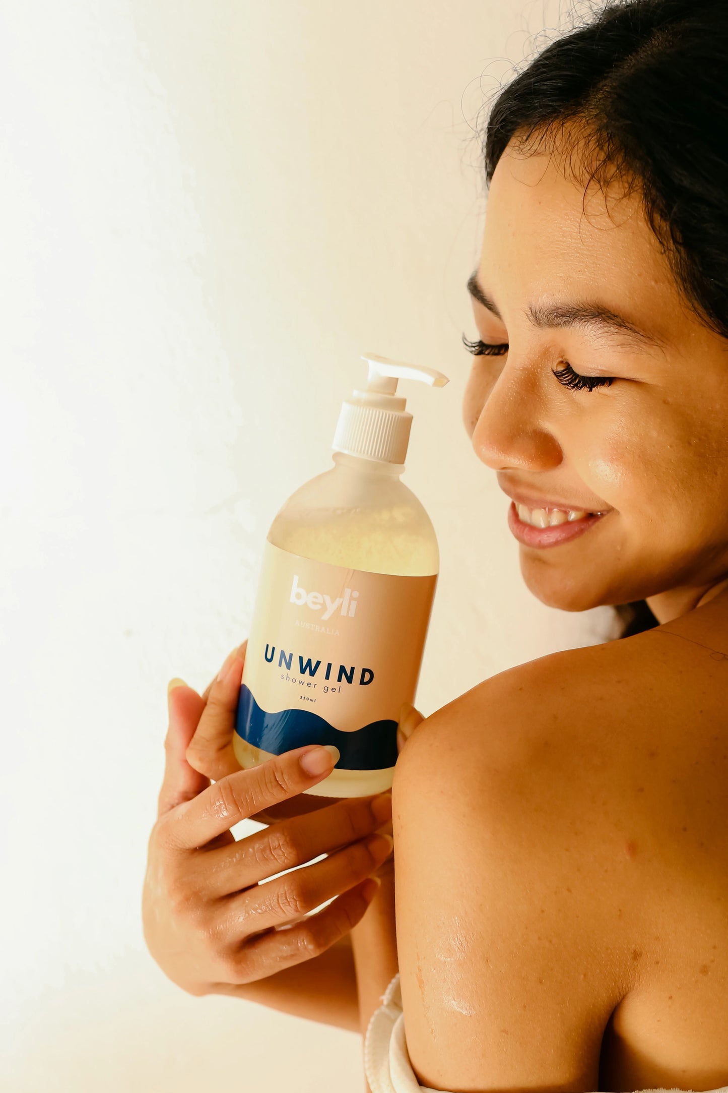 Woman showcasing Sleep Bundle Essentials body wash