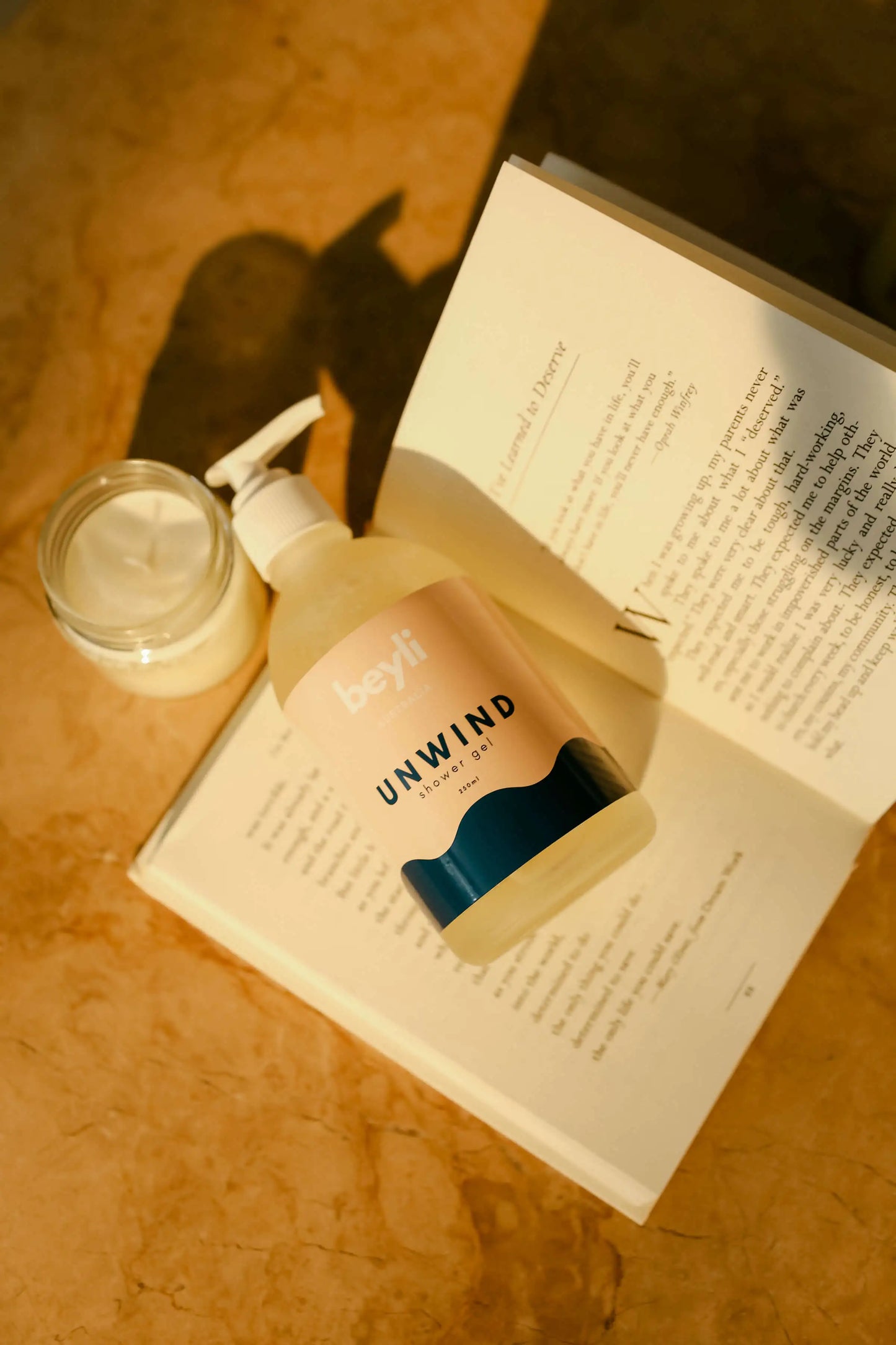 A sleep-enhancing mist and mask set presented next to a bedtime reading book