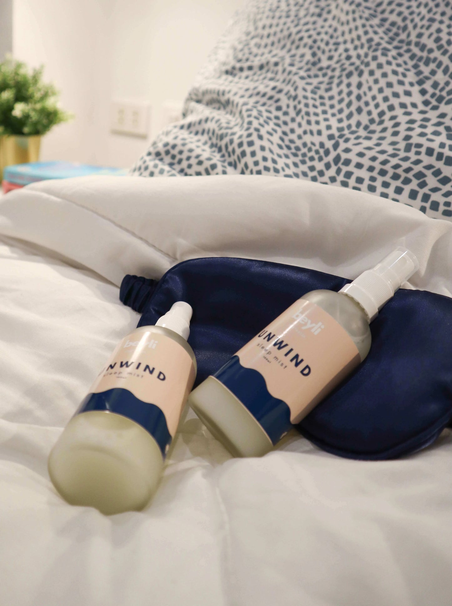 A pair of Better Sleep lotions next to a soft pillow to promote relaxation