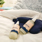 Sleep Bundle Essentials lotion pair with tote bag arranged on a bed