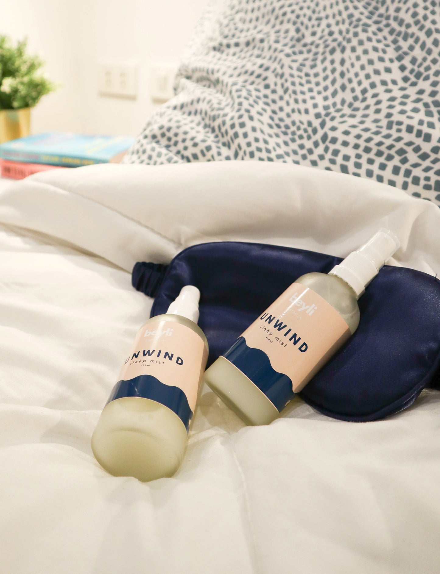 Sleep Bundle Essentials lotion pair with tote bag arranged on a bed