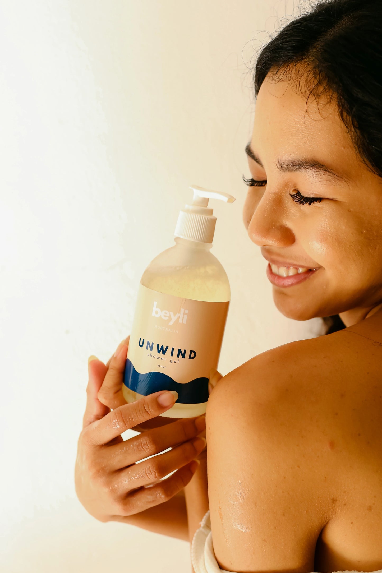 A woman displaying a bottle of Good Night Shower Gel